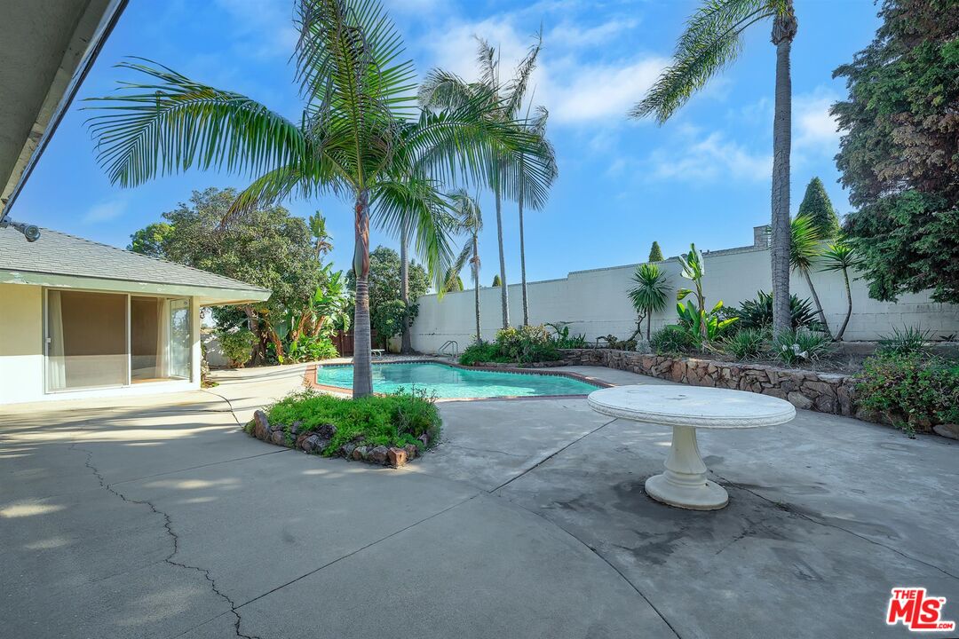 4320 Monteith Drive View Park, CA 90043 - Photo 17 of 17 a white house with palm trees in front of it