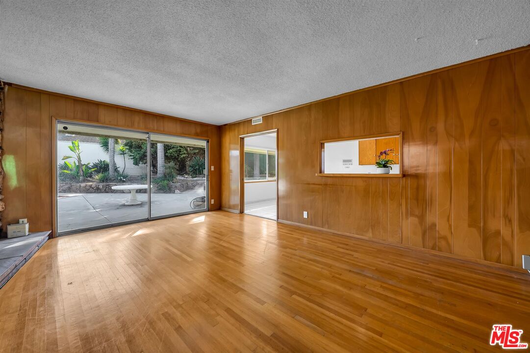 4320 Monteith Drive View Park, CA 90043 - Photo 4 of 17 a view of an empty room with wooden floor and a window