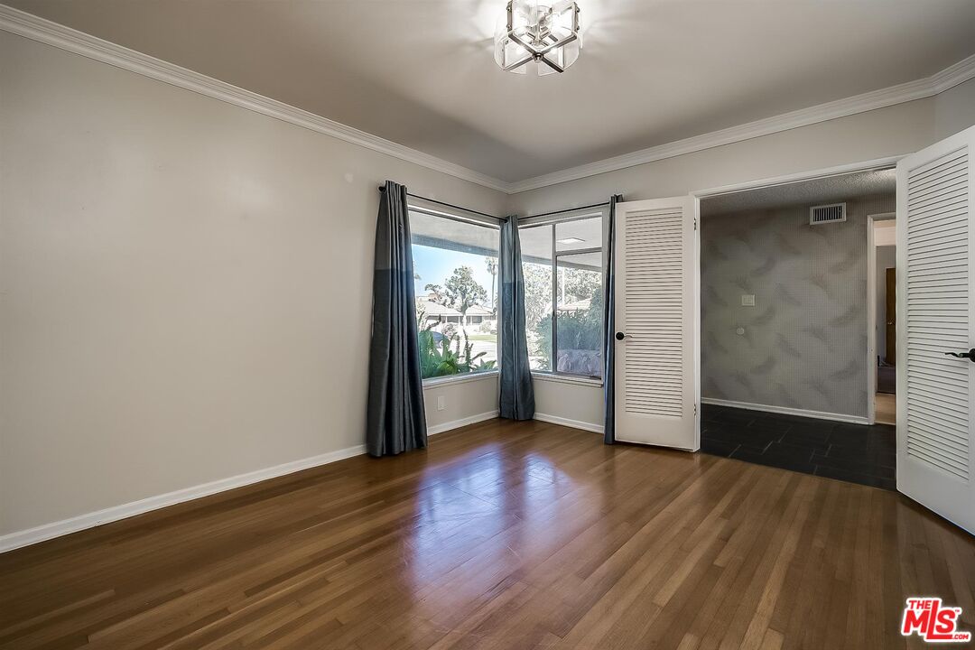 4320 Monteith Drive View Park, CA 90043 - Photo 7 of 17 a view of an empty room with wooden floor and a window