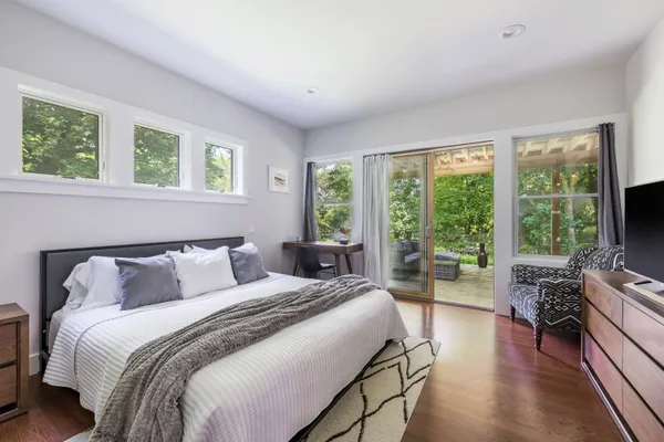 a bedroom with a bed and a flat screen tv