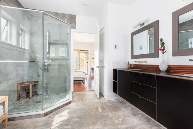 a spacious bathroom with a shower sink and mirror