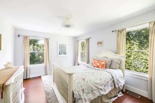 a bedroom with a large bed and a window