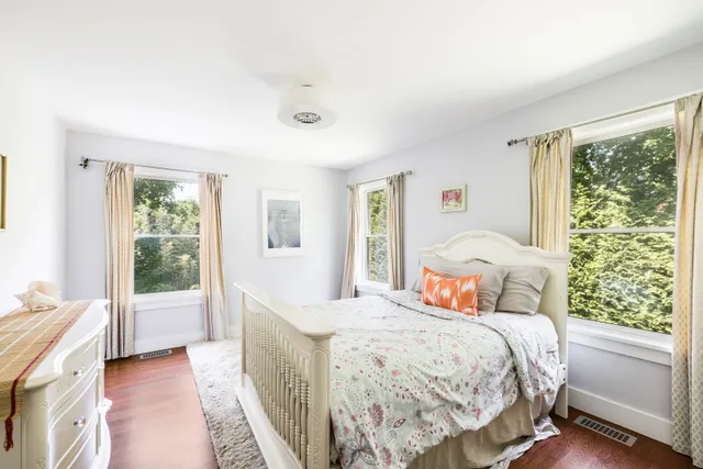 a bedroom with a large bed and a window