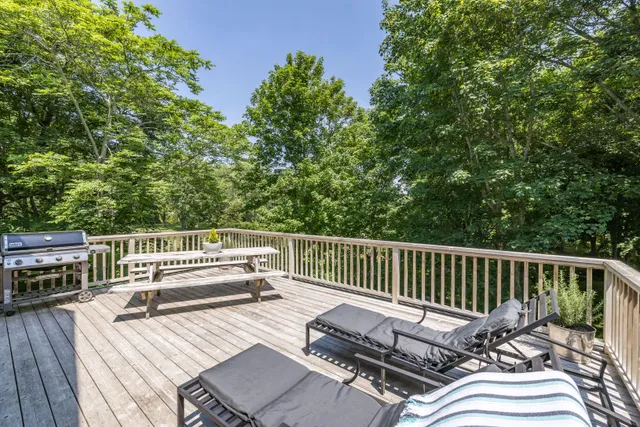 a balcony with wooden floor and fence
