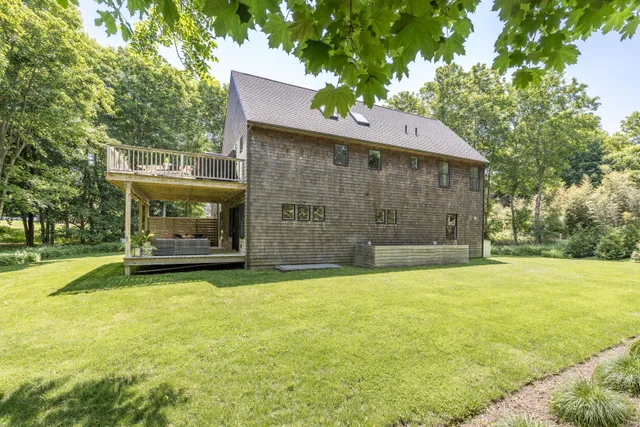 a front view of a house with a garden and yard
