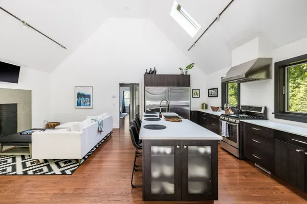 a kitchen with a table chairs and white appliances