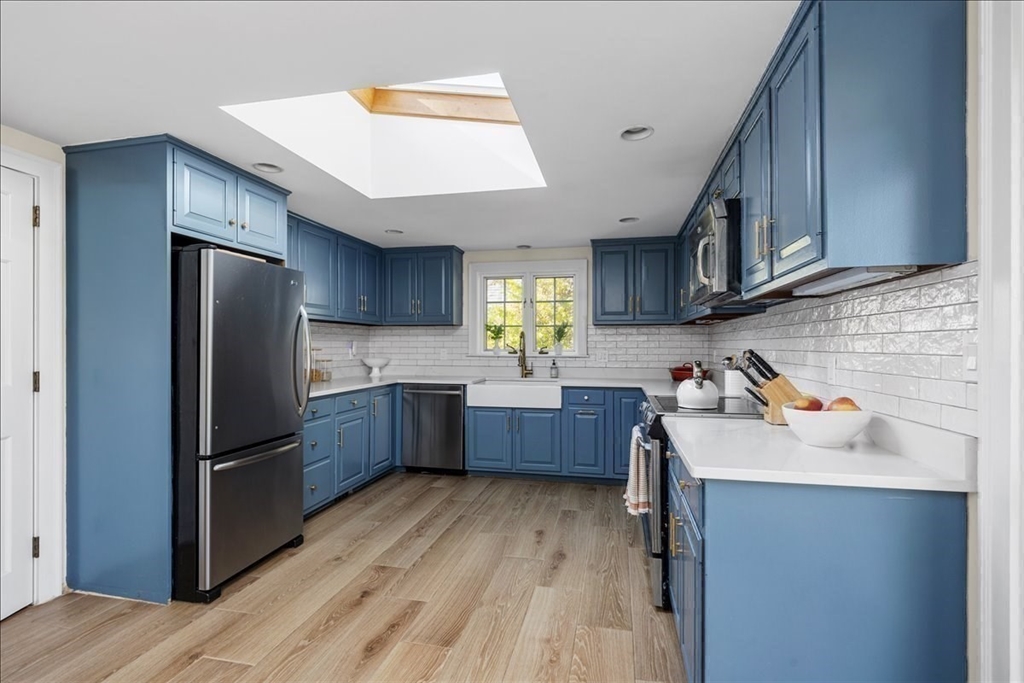12 Merrymount Road Hingham, MA 02043 - Photo 8 of 18 a kitchen with a refrigerator sink and wooden cabinets