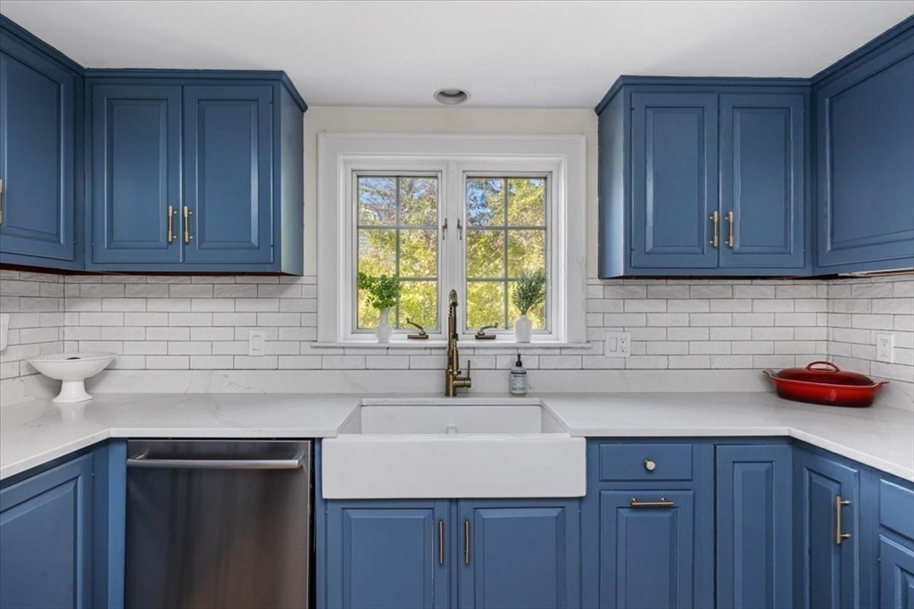12 Merrymount Road Hingham, MA 02043 - Photo 9 of 18 a kitchen with stainless steel appliances granite countertop a sink and wooden cabinets