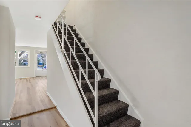 a view of staircase with wooden floor