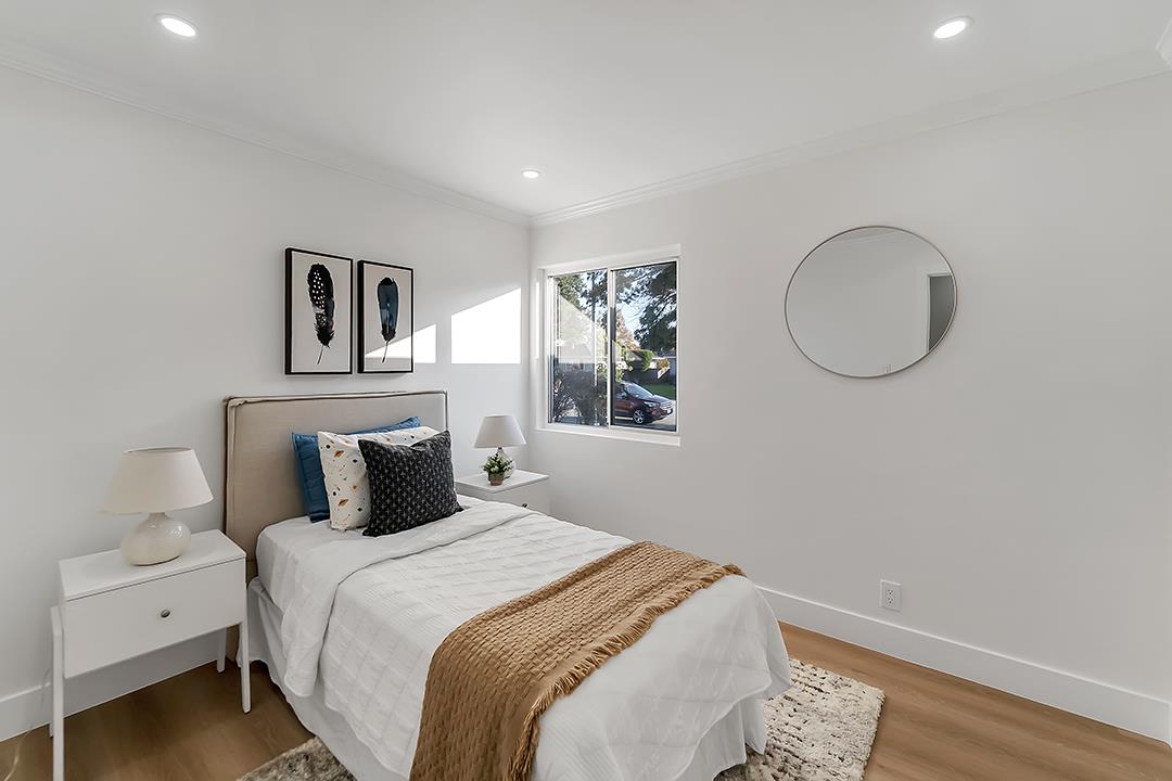 527 Maple Avenue Milpitas, CA 95035 - Photo 18 of 30 a bedroom with a large bed and a lamp