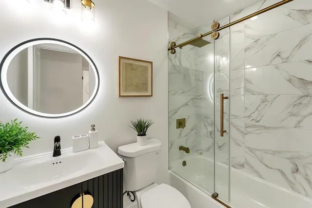 a bathroom with a sink toilet and shower