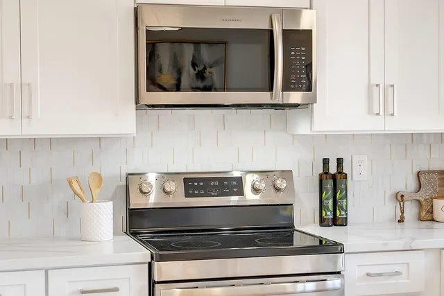 a kitchen with stove and cabinets