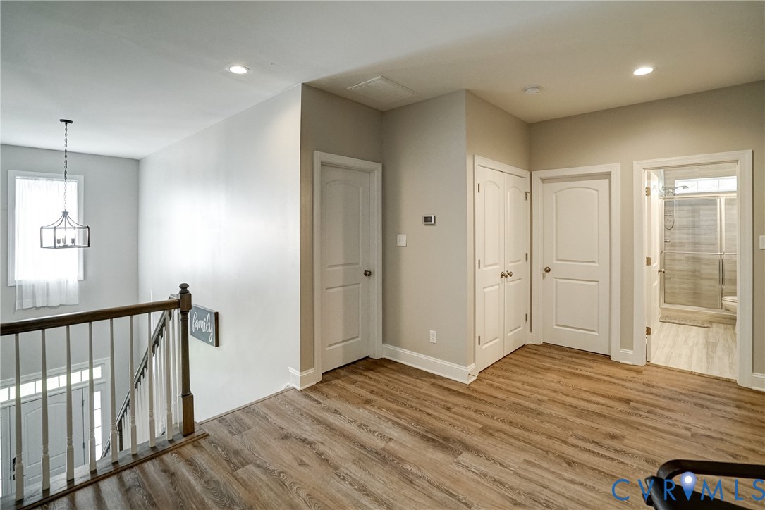 4669 Woburn Road Providence Forge, VA 23140 - Photo 41 of 78 a view of a hallway with wooden floor and a bathroom