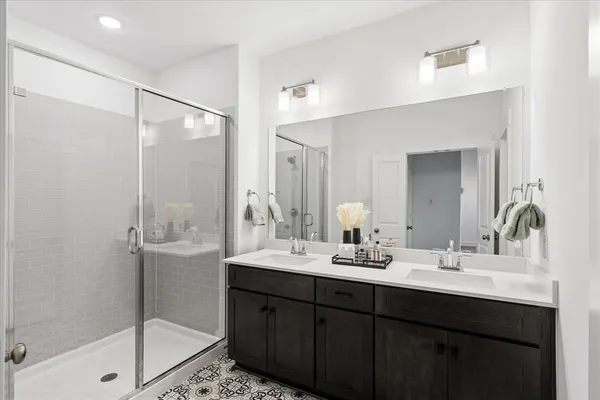 a bathroom with a shower sink and mirror