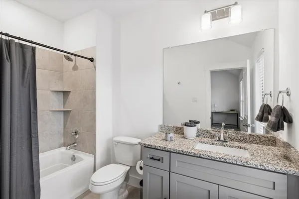 a bathroom with a bathtub and a toilet