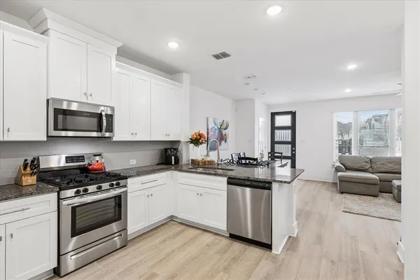 a kitchen with granite countertop a sink and cabinets