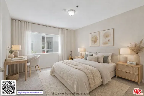 a bedroom with a white bed and white furniture