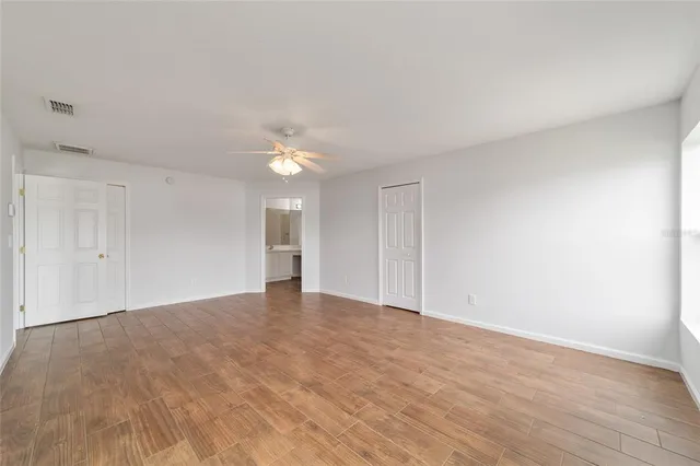 a view of a hallway with wooden floor