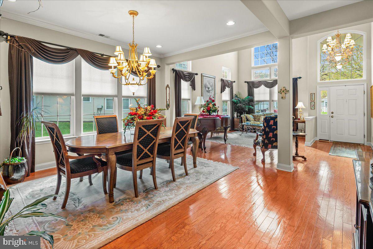 9 Spring Lake Court Barnegat, NJ 08005 - Photo 11 of 68 a view of a dining room and livingroom with furniture wooden floor a chandelier