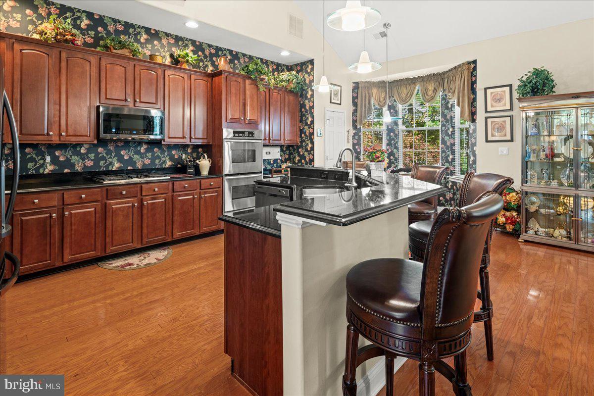 9 Spring Lake Court Barnegat, NJ 08005 - Photo 25 of 68 a kitchen with stainless steel appliances granite countertop a table chairs sink and cabinets