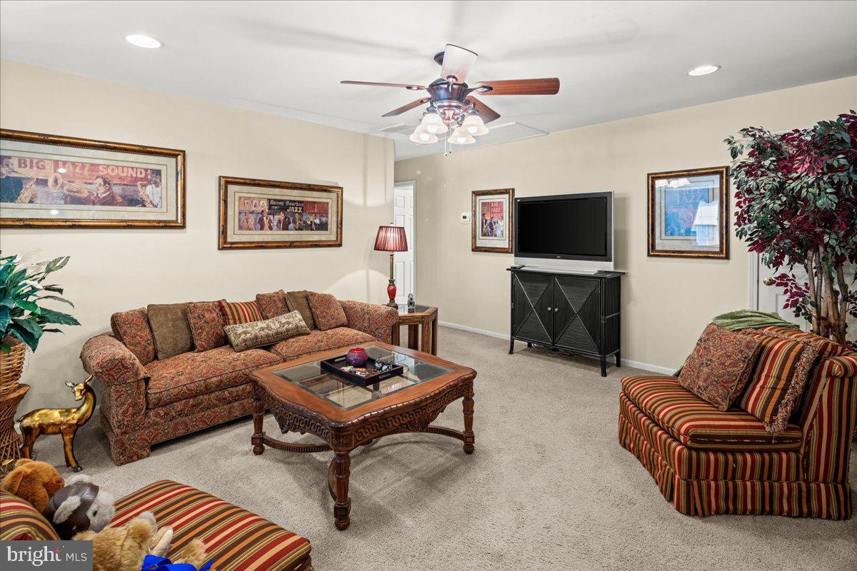 9 Spring Lake Court Barnegat, NJ 08005 - Photo 36 of 68 a living room with furniture a flat screen tv and a fireplace