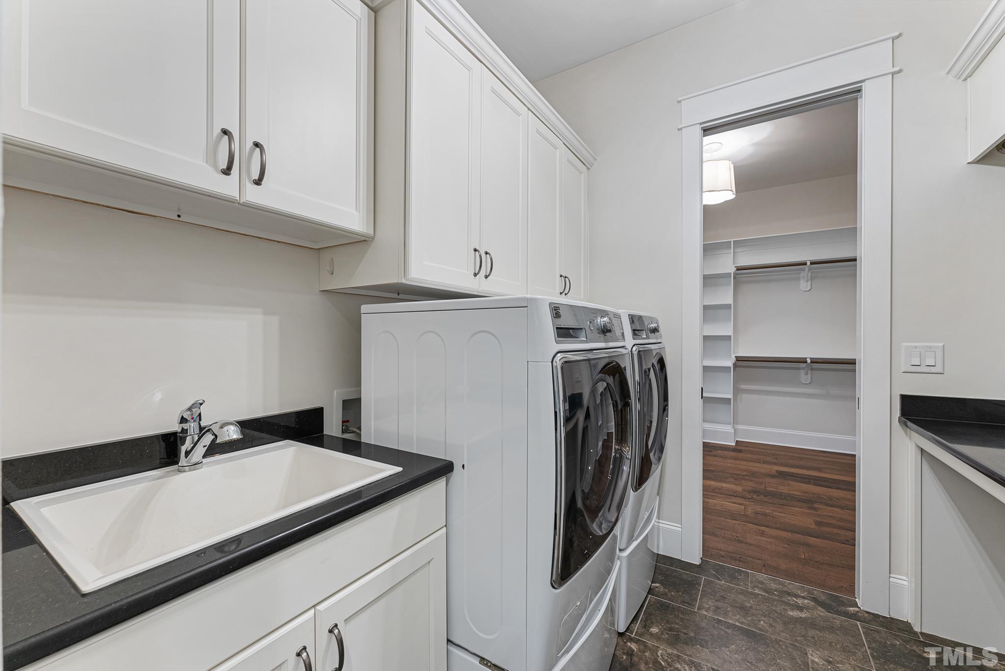 702 Cranbrook Road Raleigh, NC 27609 - Photo 26 of 57 a view of a storage and utility room with washer and dryer