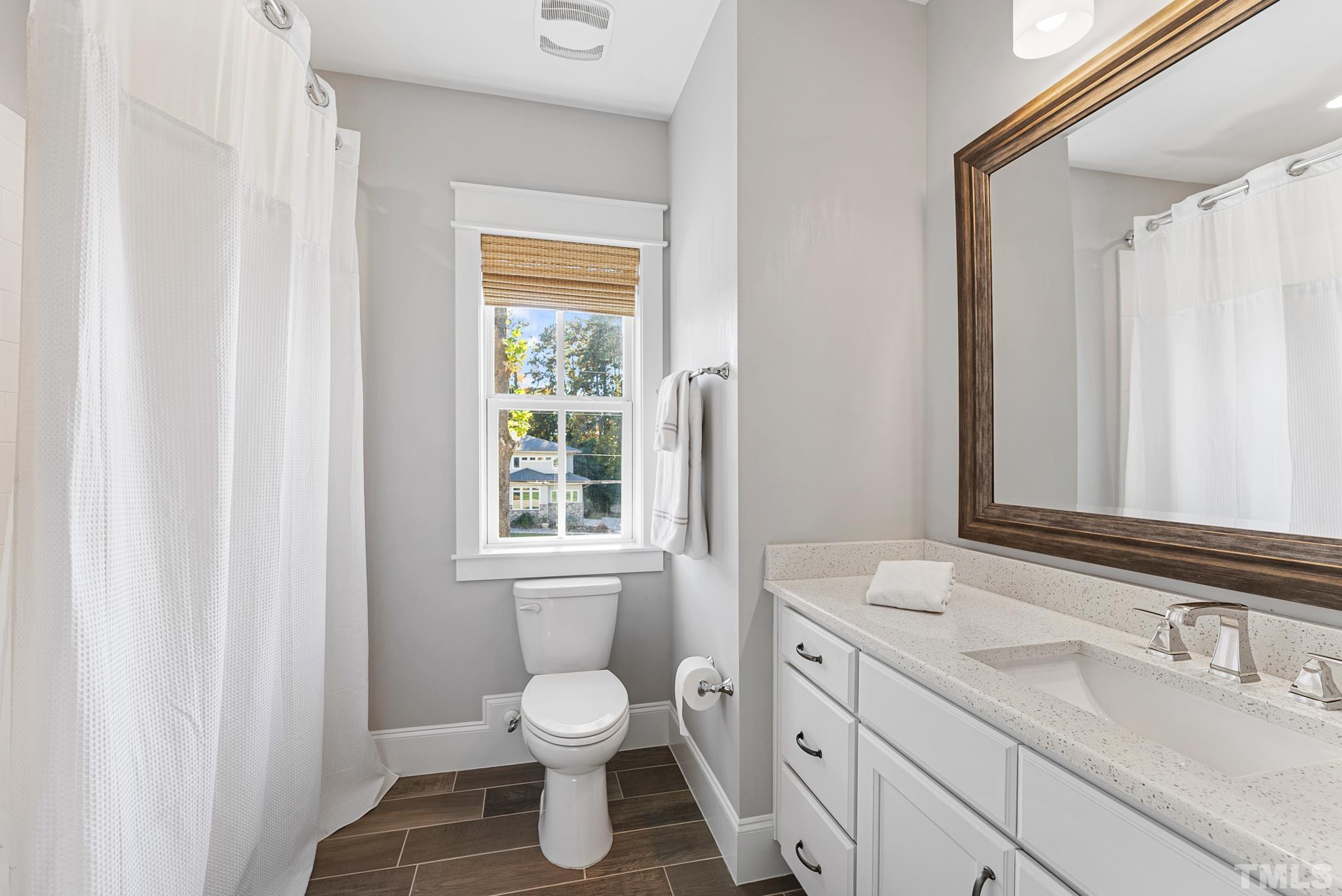 702 Cranbrook Road Raleigh, NC 27609 - Photo 36 of 57 a bathroom with a sink toilet and window