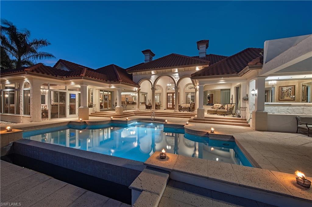 600 Galleon Drive Naples, FL 34102 - Photo 1 of 10 a front view of a house with swimming pool