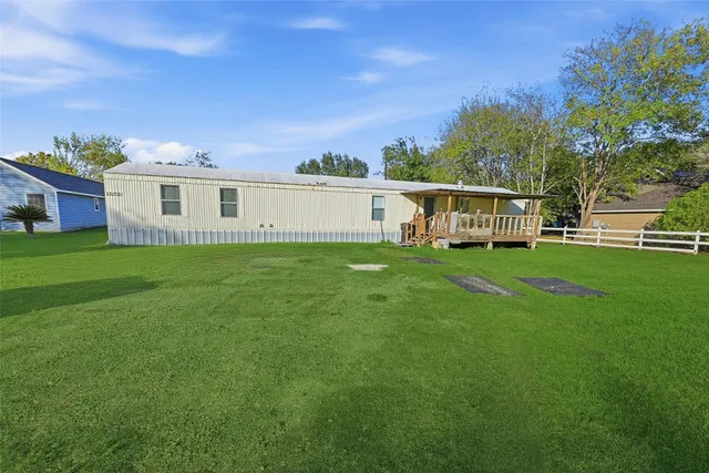 a view of a house with a yard and sitting area