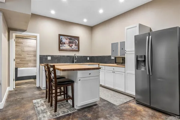 a kitchen with refrigerator and sink