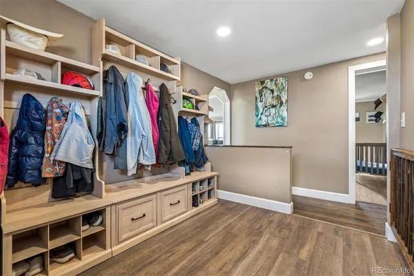 a view of a walk in closet with clothes and shoes