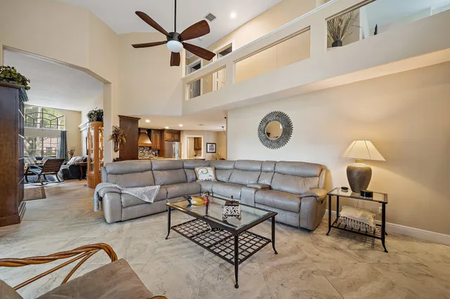 a living room with furniture a rug and a clock