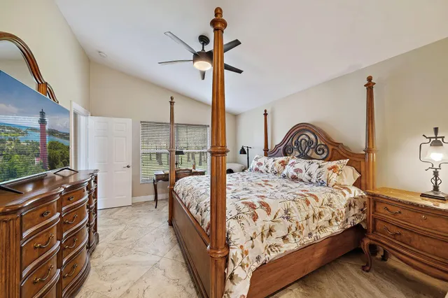 a bed sitting in a bedroom next to a window