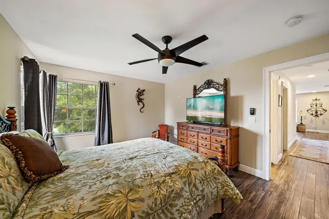 a bedroom with a bed and a large window