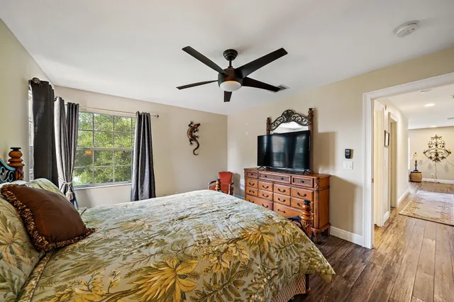 a bedroom with a bed and a large window