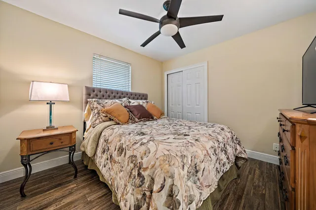 a bed sitting in a bedroom next to a lamp