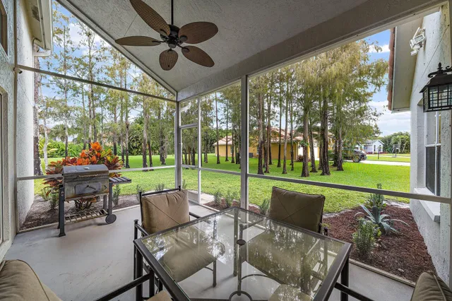 a view of a patio with a table chairs and a backyard
