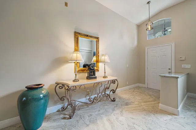 a view of a workspace with furniture and a mirror