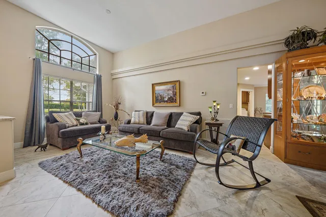a living room with furniture couches and a dining table with wooden floor