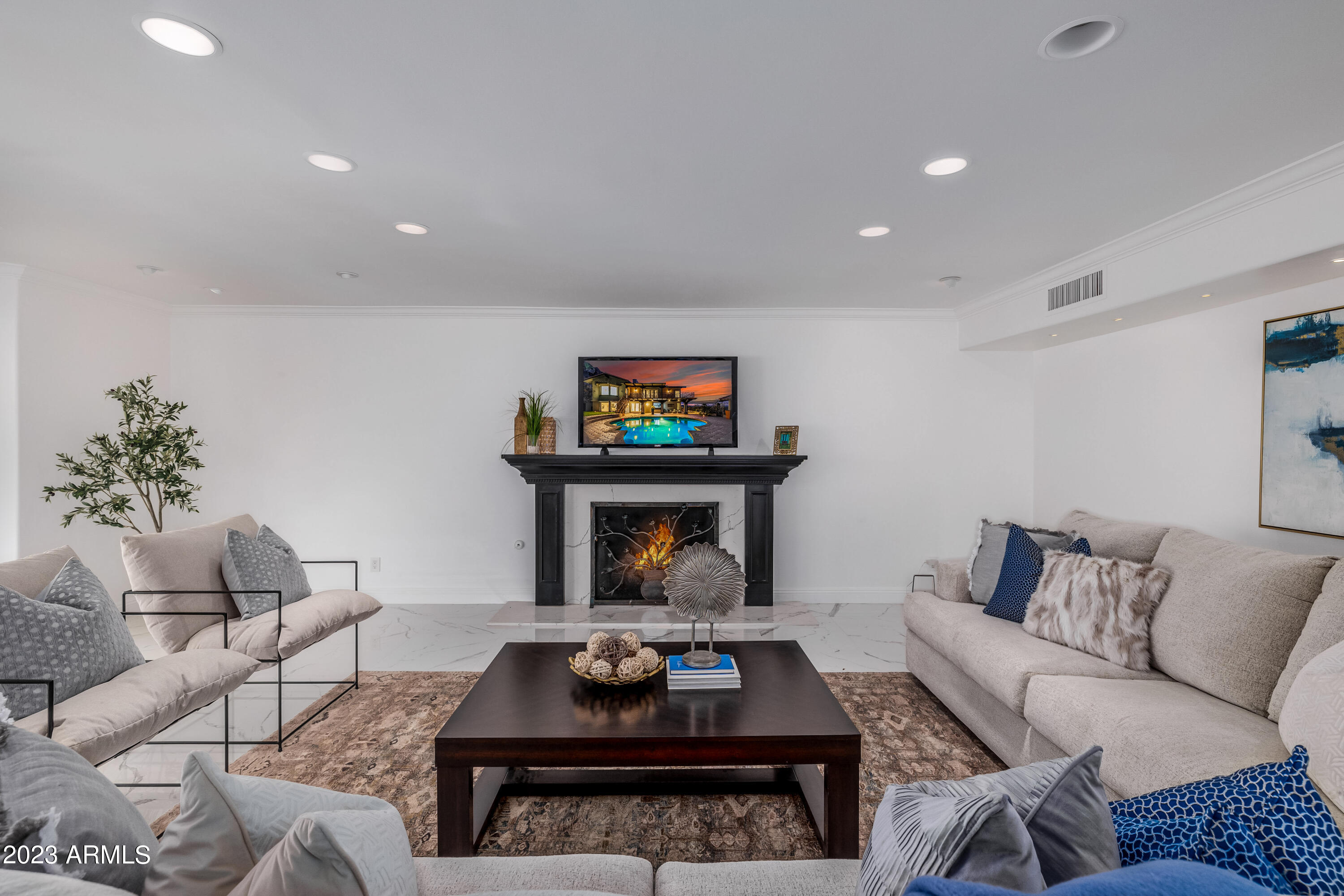 5339 East Desert Vista Road Paradise Valley, AZ 85253 - Photo 16 of 93 a living room with furniture and a fireplace
