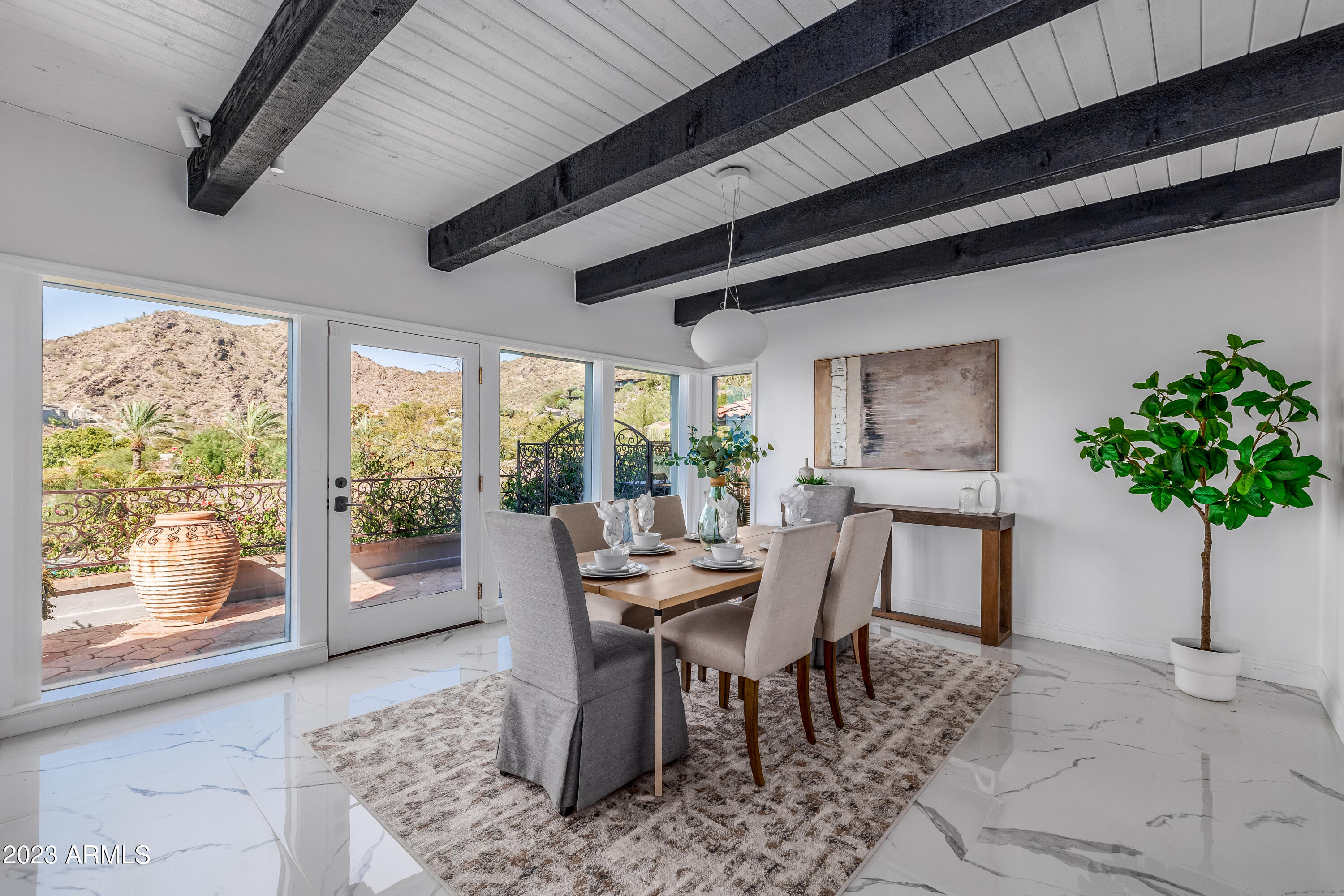 5339 East Desert Vista Road Paradise Valley, AZ 85253 - Photo 19 of 93 a dining room with furniture window and wooden floor