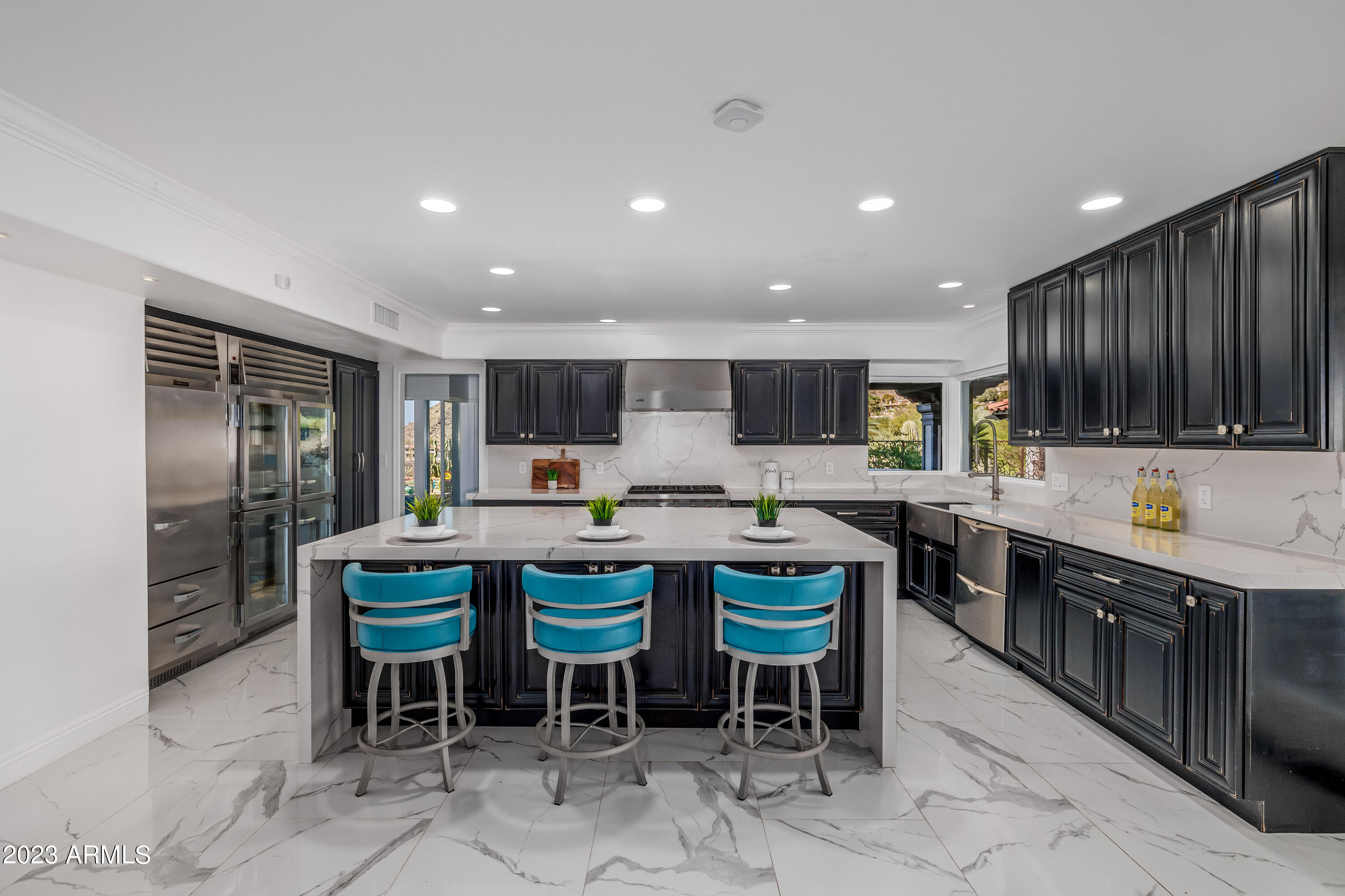 5339 East Desert Vista Road Paradise Valley, AZ 85253 - Photo 21 of 93 a kitchen with lots of wooden cabinets a sink and appliances