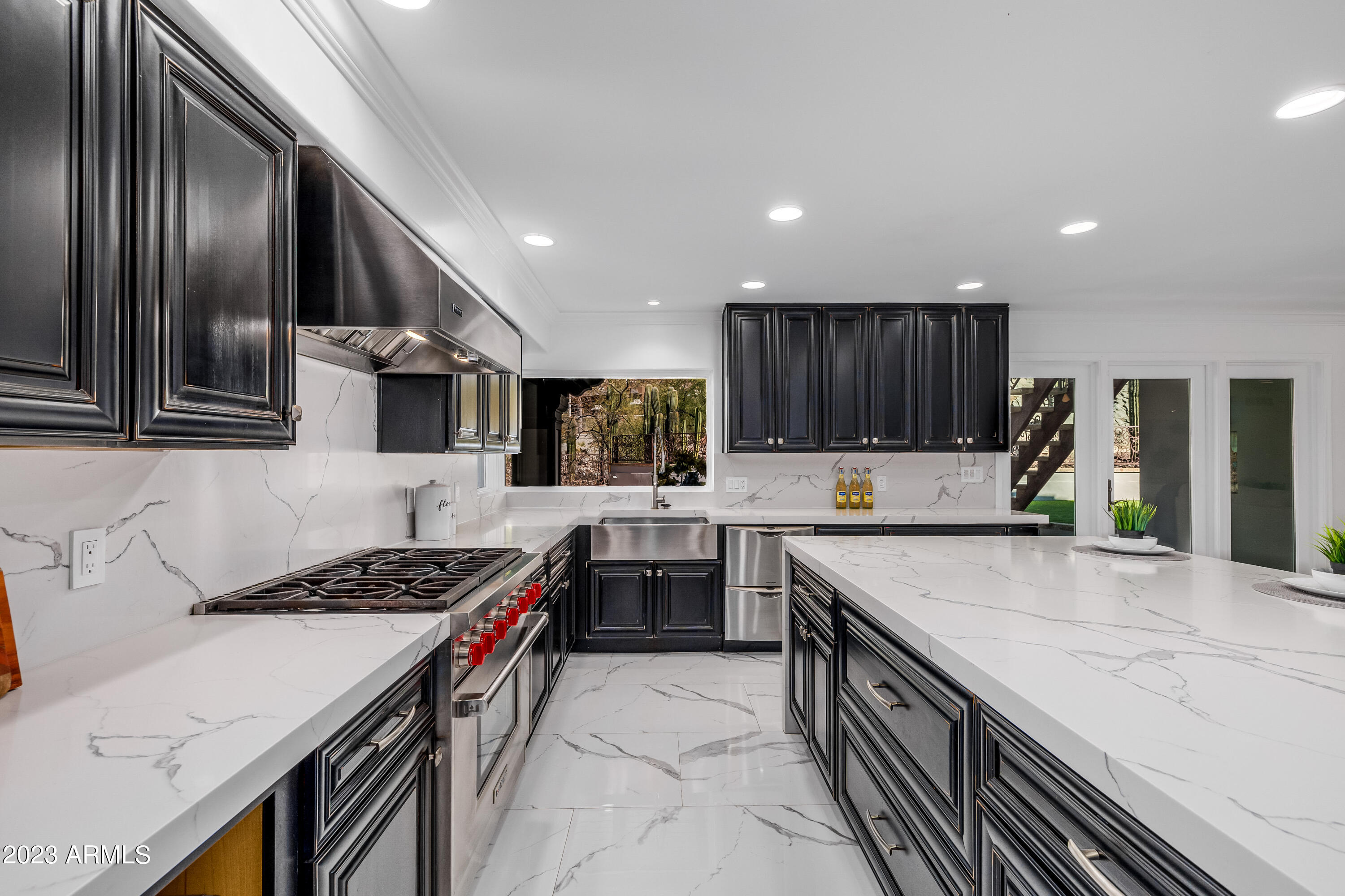 5339 East Desert Vista Road Paradise Valley, AZ 85253 - Photo 22 of 93 a kitchen with stainless steel appliances granite countertop a stove top oven a sink and dishwasher a oven with wooden cabinets