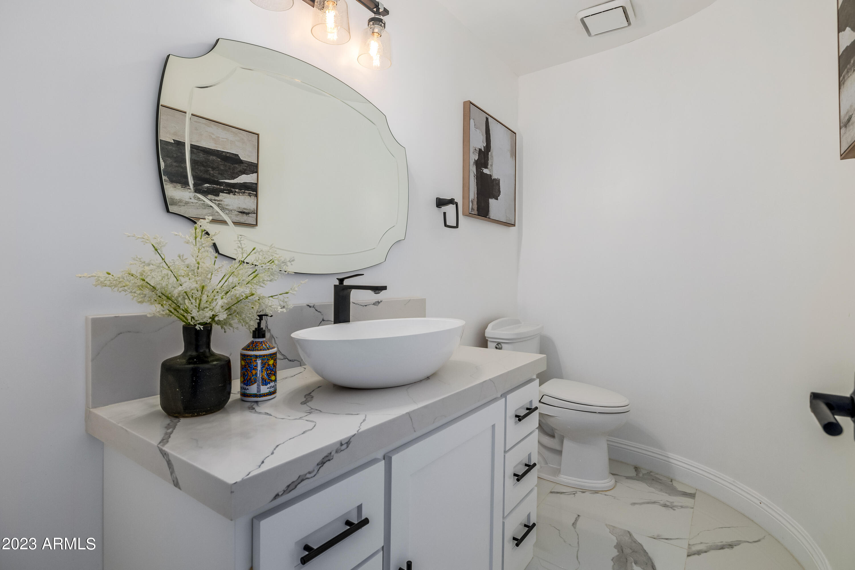 5339 East Desert Vista Road Paradise Valley, AZ 85253 - Photo 25 of 93 a bathroom with a toilet a sink and mirror