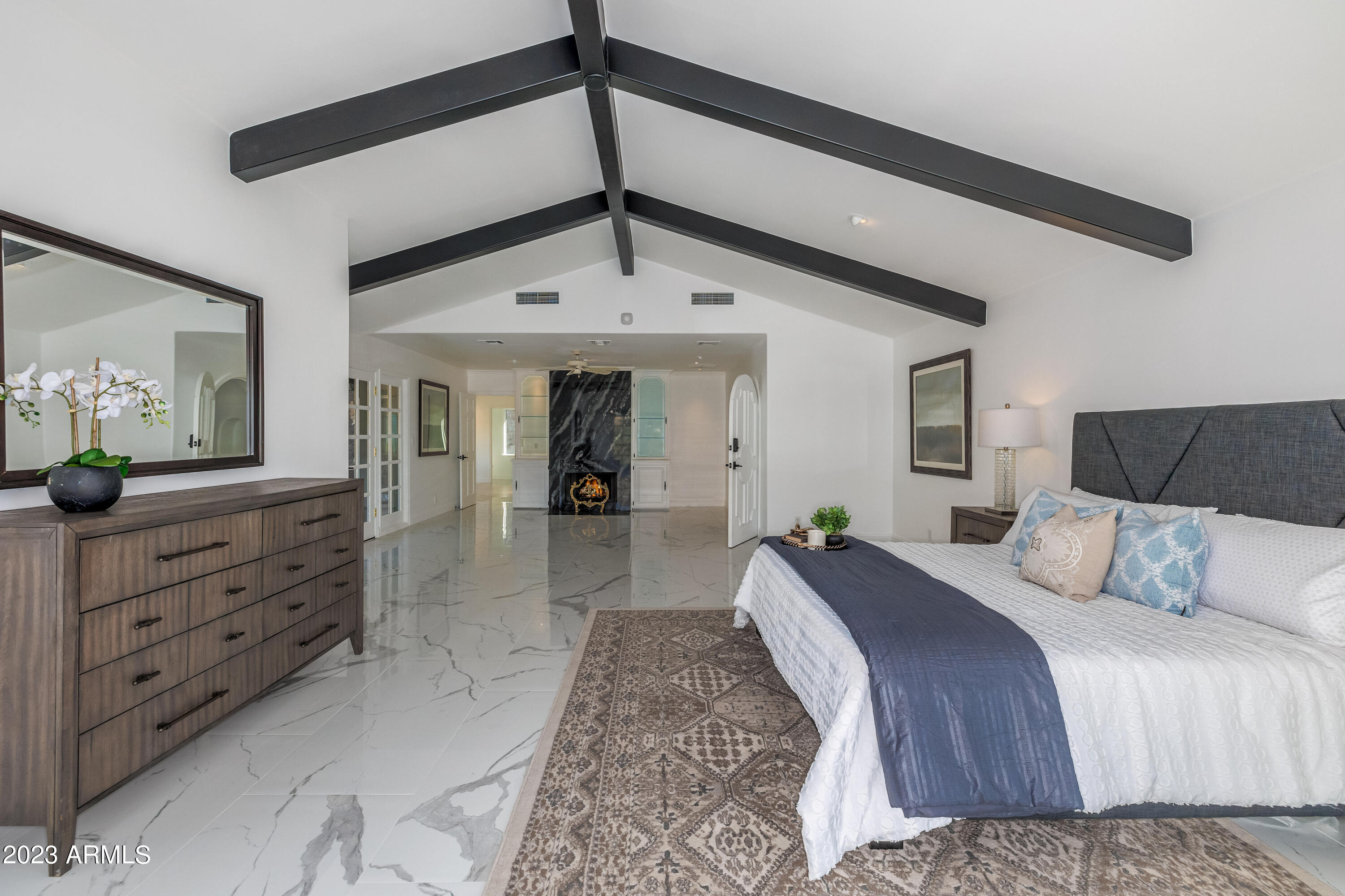 5339 East Desert Vista Road Paradise Valley, AZ 85253 - Photo 28 of 93 a spacious bedroom with a bed a dresser and potted plant