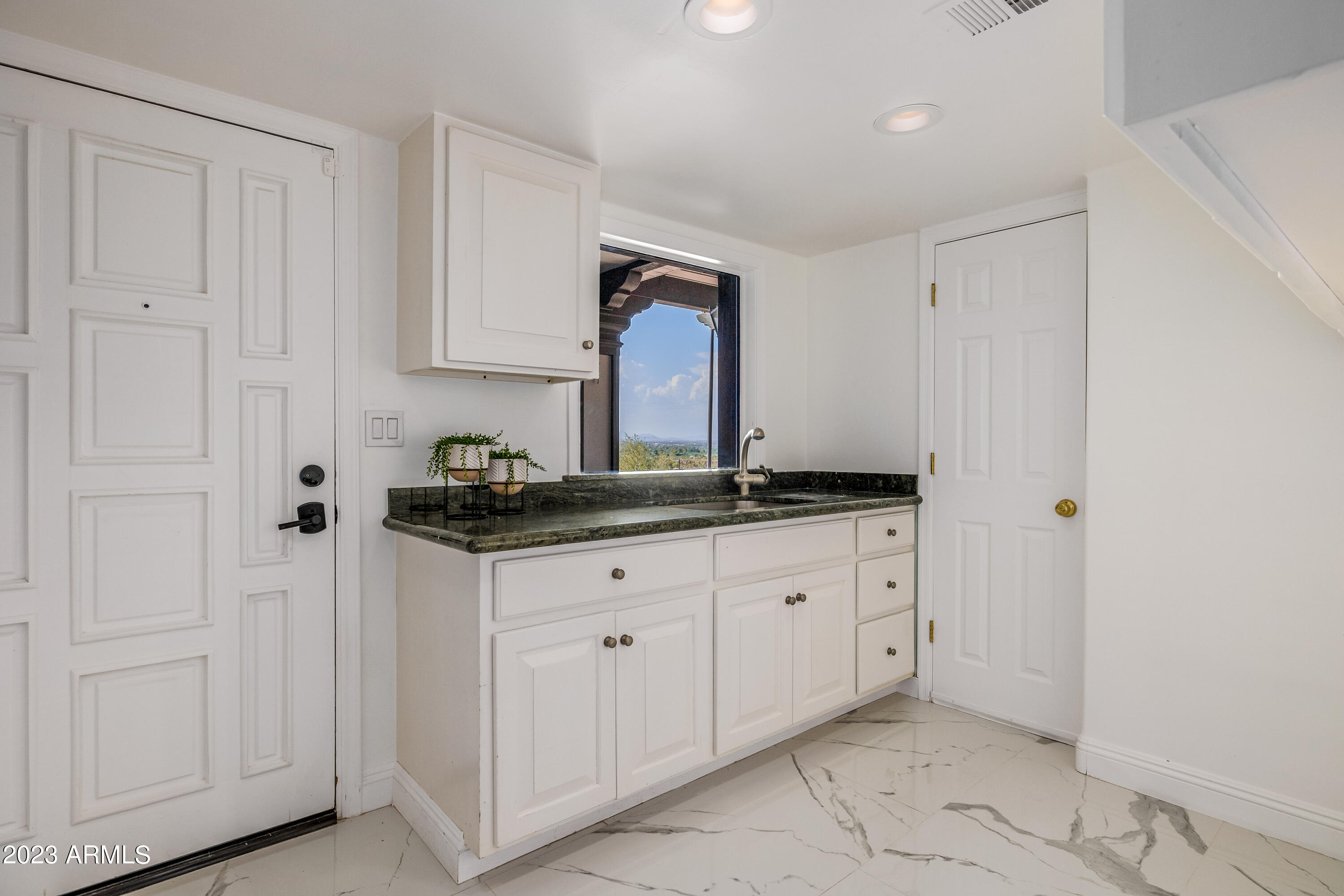 5339 East Desert Vista Road Paradise Valley, AZ 85253 - Photo 57 of 93 a bath room with granite countertop white cabinets and sink