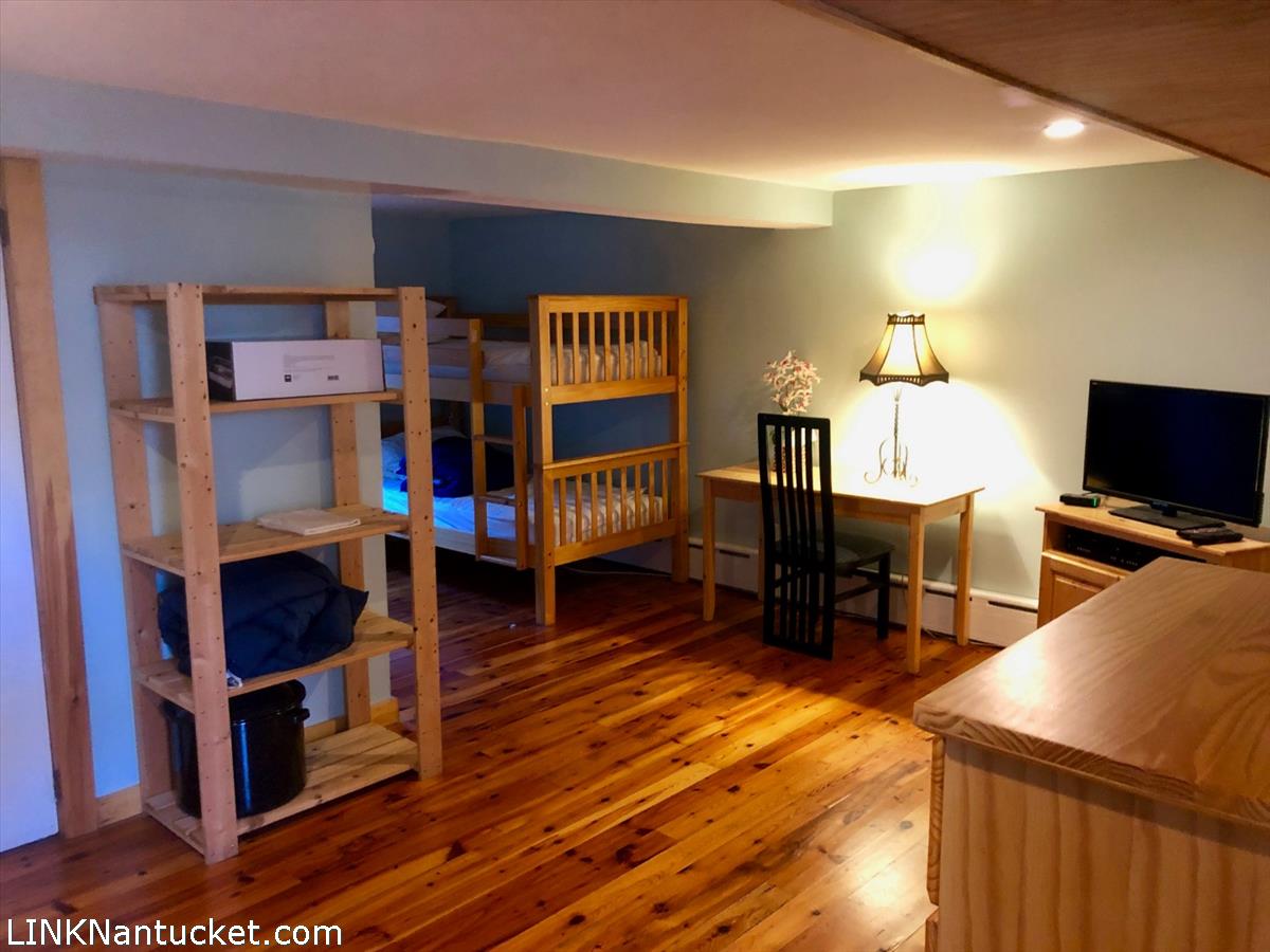 8 M Street Nantucket, MA 02554 - Photo 10 of 20 a bedroom with furniture and a wooden floor
