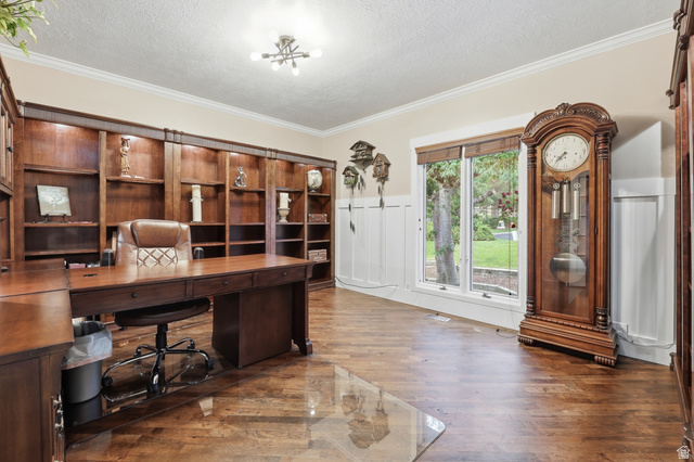 2342 Charros Road Sandy, UT 84092 - Photo 9 of 94 Room featuring extensive built-in wooden shelving, wood-finish flooring, and crown molding
