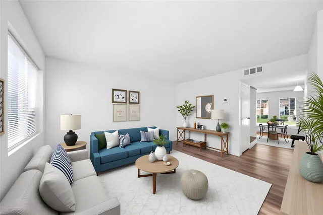 a living room with furniture and wooden floor