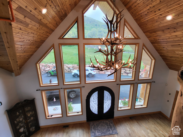 1406 South Bartholomew Cyn Road Springville, UT 84663 - Photo 2 of 19 Foyer entrance with a chandelier, vaulted ceiling, wood ceiling, light wood finished floors, and french doors